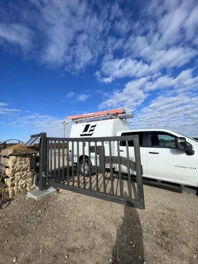 new residential access gate next to Lightning Electric service truck