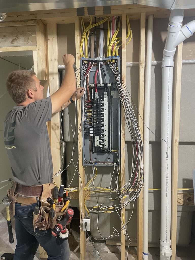Rick Lee, owner of Lightning Electric, wiring a residential electrical panel in new construction