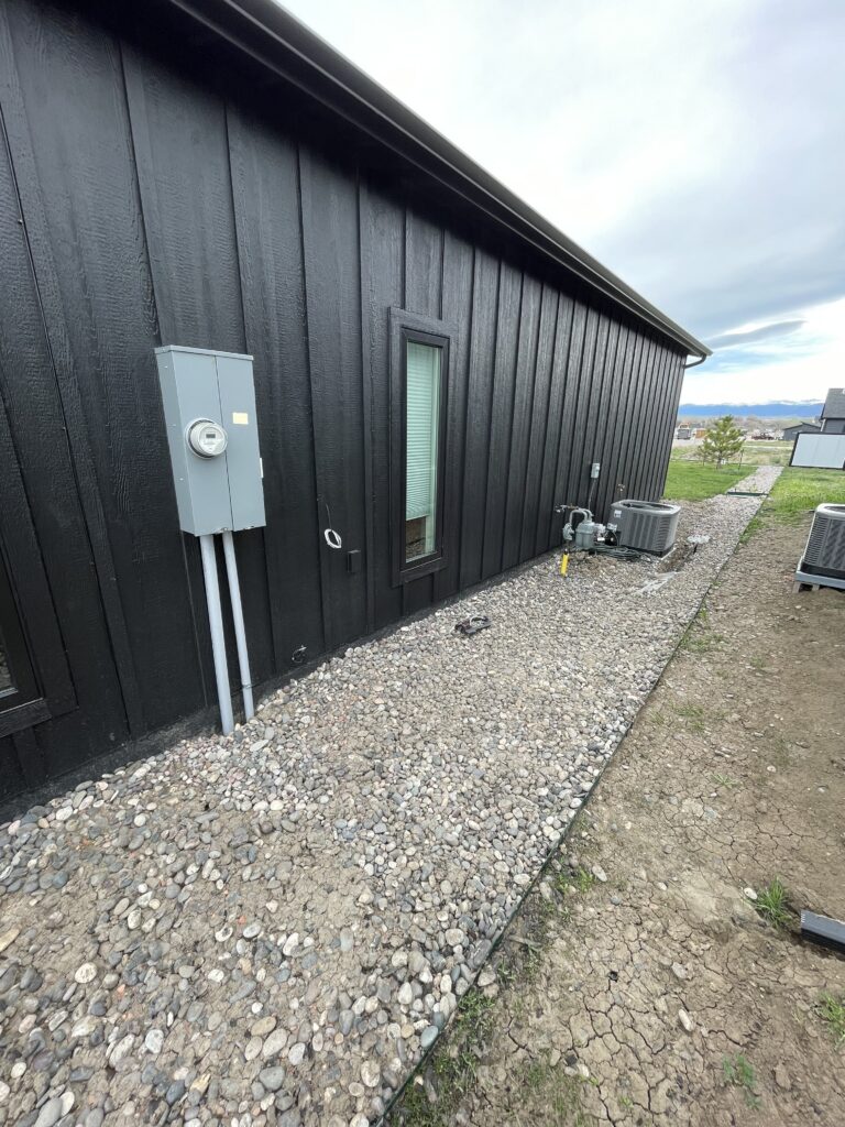 whole house electrical generator installed on shop exterior